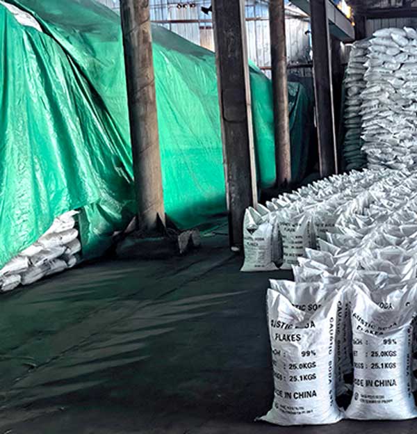 Symmetrical dual stack pallet layout of caustic soda flakes GACL bags lined up inside warehouse staging aisle