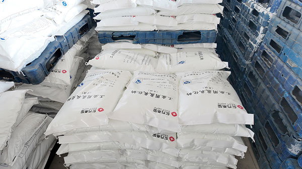 Nearby chemical warehouse storing high purity caustic soda flakes for local industrial use