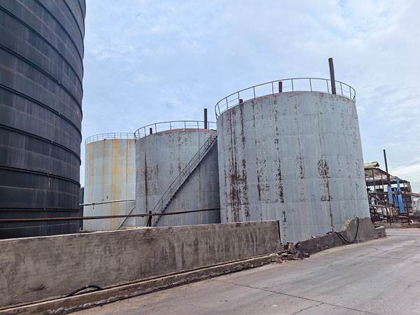 Modern industrial warehouse exterior storing bulk cargo of caustic soda pearl 25kg pallets