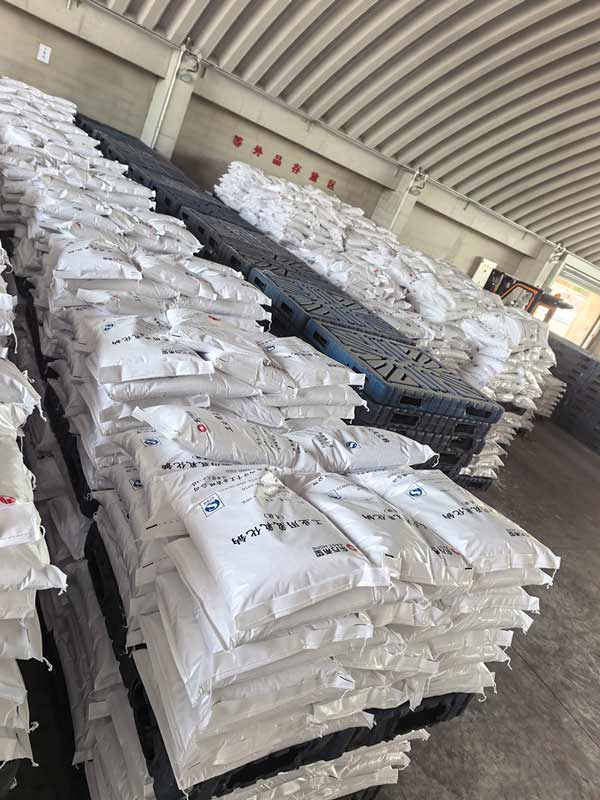 Shipping container loaded with palletized 25kg bags of caustic soda pearls for export