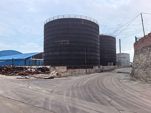 Industrial storage silo storing freshly prilled high density caustic soda pearls at factory