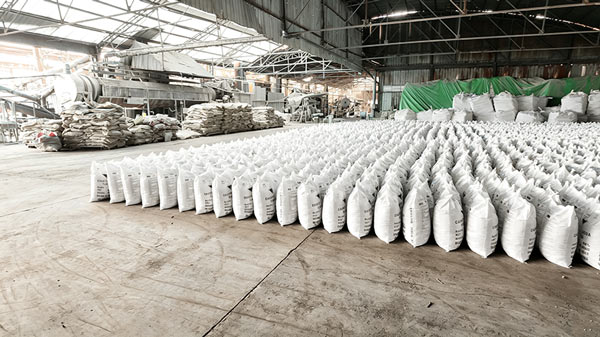 Warehouse inventory stack of 1kg caustic soda bags ready for export