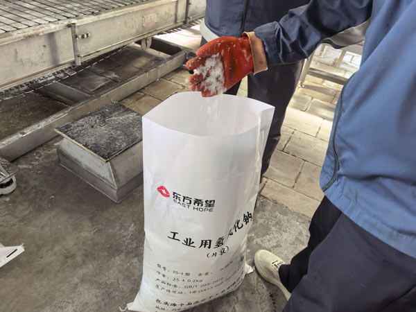 High purity sodium hydroxide white chemical flakes close up detail