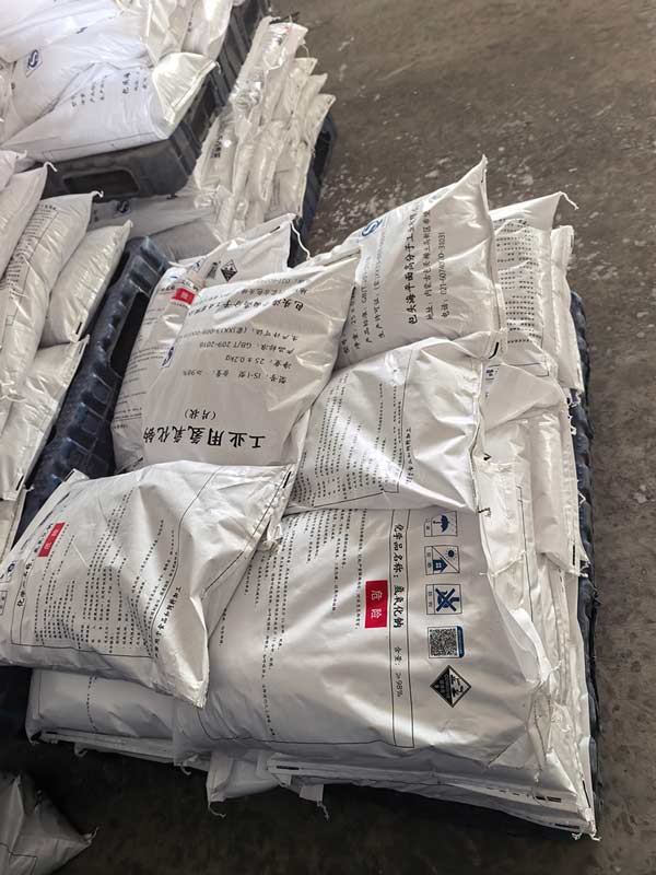 Local hardware supplier showcasing sealed high purity caustic soda bags on retail shelves