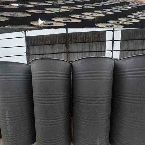 Bulk chemical packaging facility showing rows of caustic solid drums