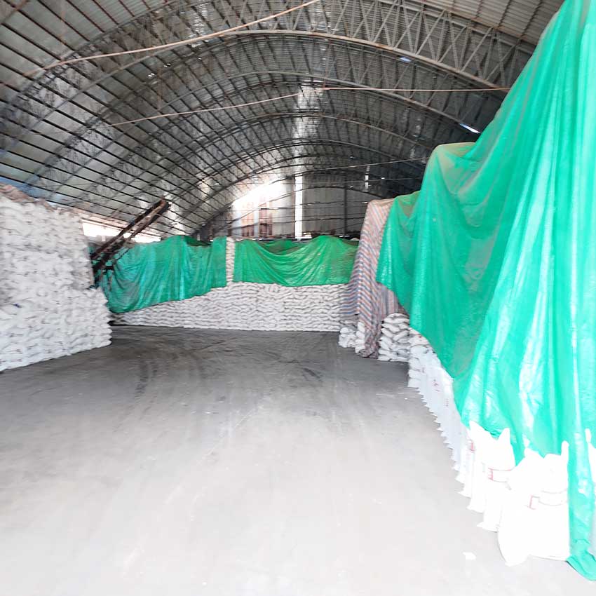 Large warehouse stock of stacked sodium hydroxide bags for wholesale soap making supply