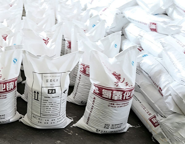 Close up shot of high-contrast black ink stamp indicating current manufacture batch date and net weight on caustic soda flakes bag