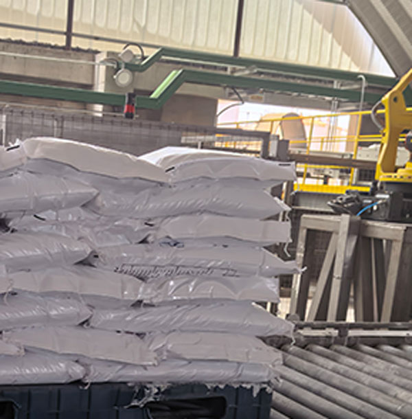 Staggered block stacking configuration of bagged caustic soda flakes sodium hydroxide stored on plastic spill pallets