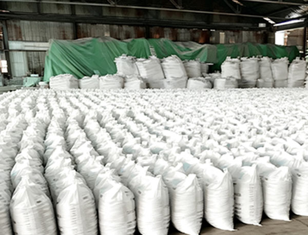Dual block stacking arrangement of palletized Shriram caustic soda flakes inventory positioned inside clean warehouse bays