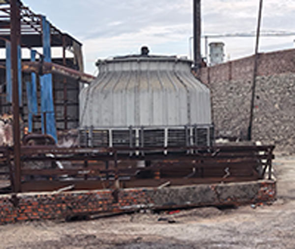 Spiral screw conveyor system transporting dense sodium hydroxide flakes into the packaging hopper of an Aditya Birla plant