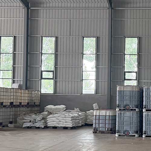Industrial bulk sodium hydroxide supply stored on pallets in factory warehouse