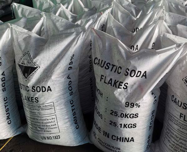 Close-up of 25.0kg standard bags of best quality sodium hydroxide flakes, highlighting the high concentration 99 percent specification.