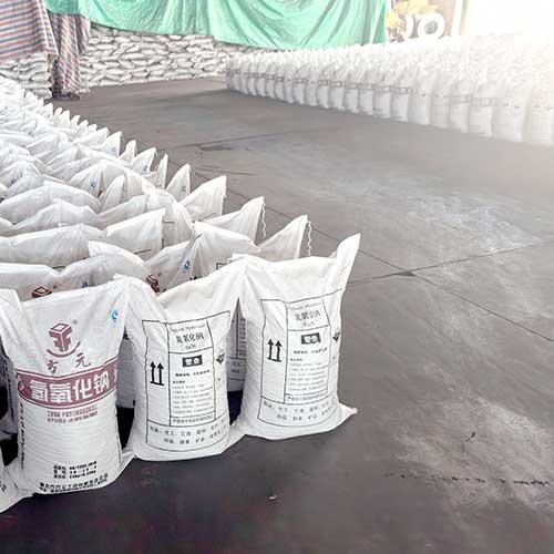 A massive inventory of sodium lye bags stacked floor-to-ceiling inside a large chemical manufacturing warehouse.