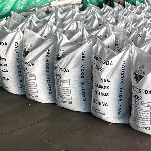 Close-up of sodium caustic bags (99% pure flakes, 25kg net weight) stacked neatly in a chemical storage warehouse.