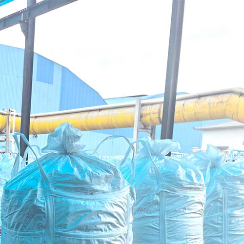 Large ton-bags of sodium hydroxide in hair products formulations, sealed for bulk ocean export to cosmetic brands.