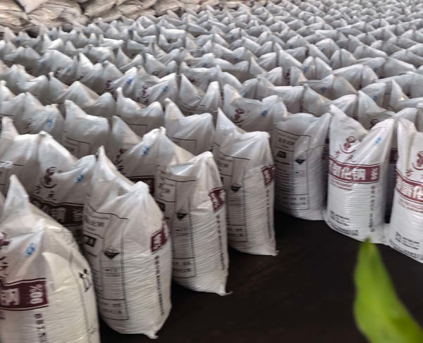 High angle shot of endless bulk caustic soda bags arrayed across factory floor for heavy industry clients.