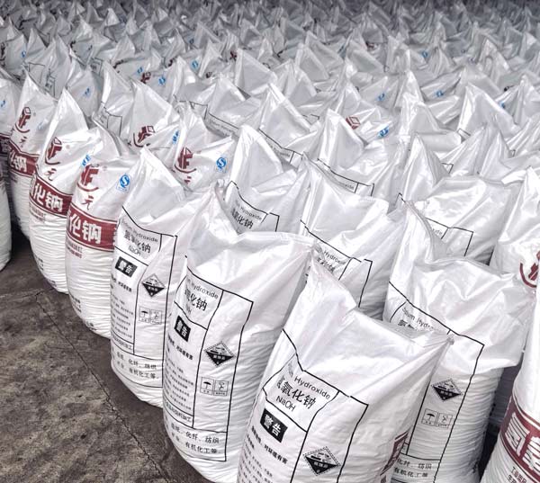 Close-up view of 25kg sodium hydroxide bags used for caustic soda and acid neutralization in chemical plants.