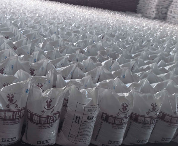 Vast warehouse inventory of caustic soda bags for large-scale acid neutralization and wastewater processing.
