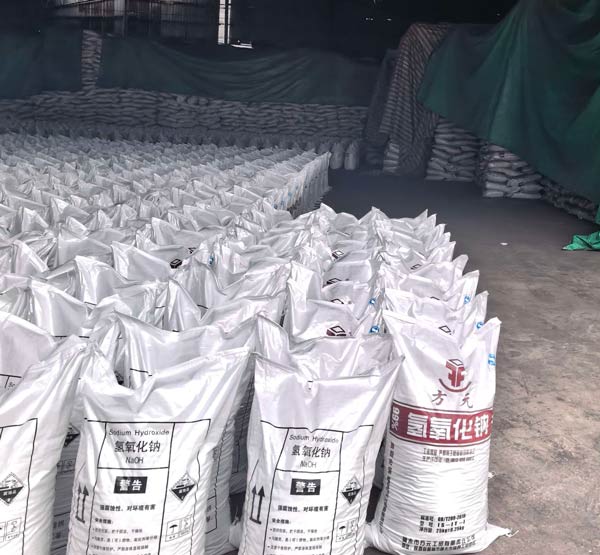 Sodium hydroxide soda bags stored in factory warehouse offering wholesale buyers optimal caustic soda market price deals.