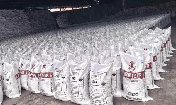 Wide view of vast warehouse inventory packed with sodium hydroxide soda bags to meet global market demand.