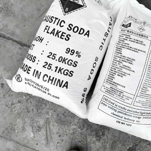 Industrial supply of sodium hydroxide 25kg bag detailing gross weight 25.1KGS and 99% purity level, positioned in a distribution facility.