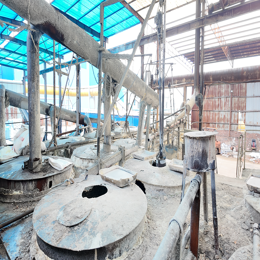 Raw chemical synthesis and flaking equipment setup inside a bulk supplier facility offering a low sodium hydroxide bulk price.