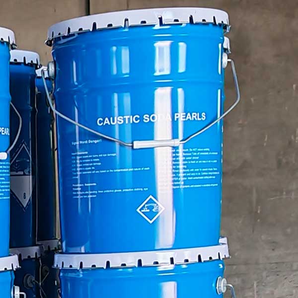 Warehouse storage view of stacked blue metal pails filled with 99% pure free-flowing caustic beads.