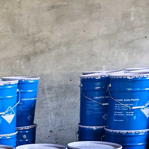 Factory-direct blue metal pails packed with 99% pure caustic soda beads for sale.