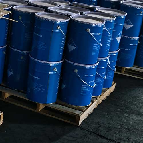 Class 8 hazard warning labeled blue chemical buckets managed by professional caustic soda beads suppliers.