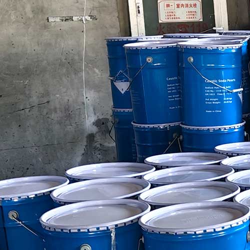 Warehouse inventory of blue chemical drums ready for prompt local factory delivery from caustic soda beads suppliers near me.