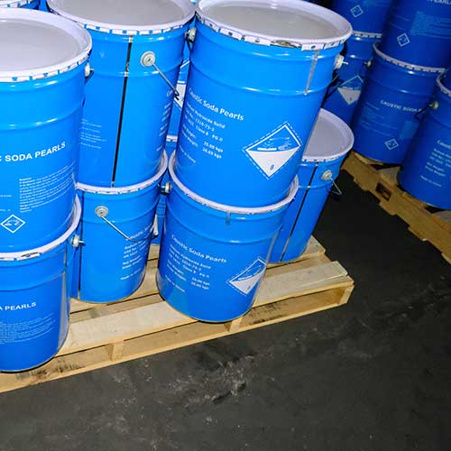 Stacked blue chemical buckets on wooden pallets ready for immediate dispatch at factory-direct caustic soda prills price.