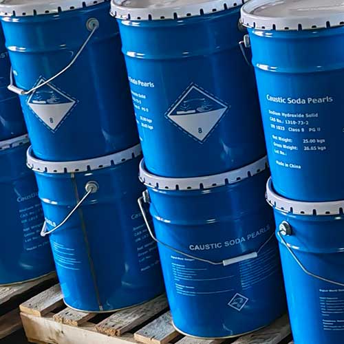 Warehouse inventory of blue metal drums ready for commercial enterprise sourcing of high-purity soda beads.