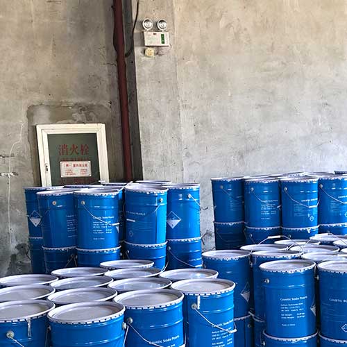 Blue metal pails stacked on wooden pallets engineered for safe maritime transport of soda with beads in it.